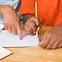 A teacher instructing a student on their homework